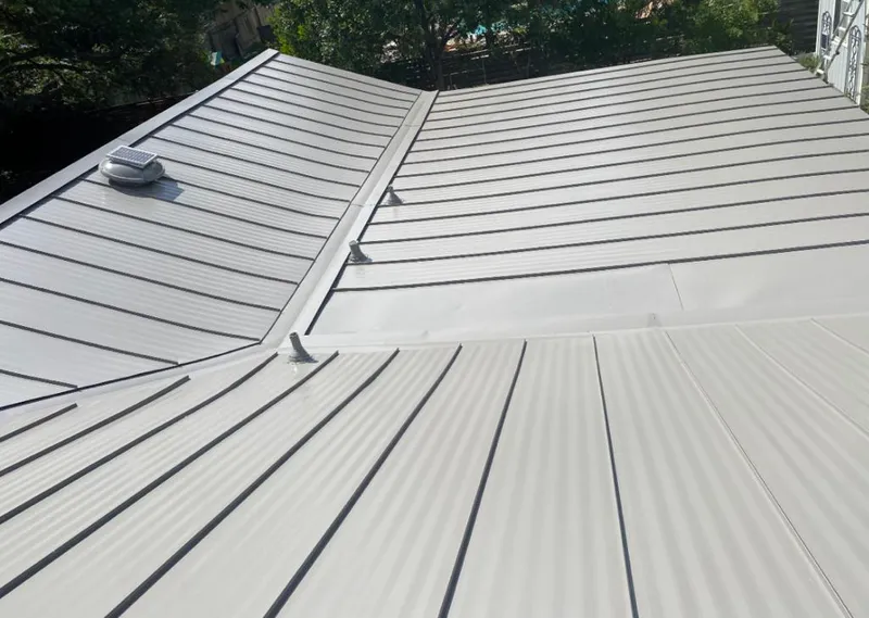 Solar attic fan installed on a metal roof for Roof Ventilation in Ontwa